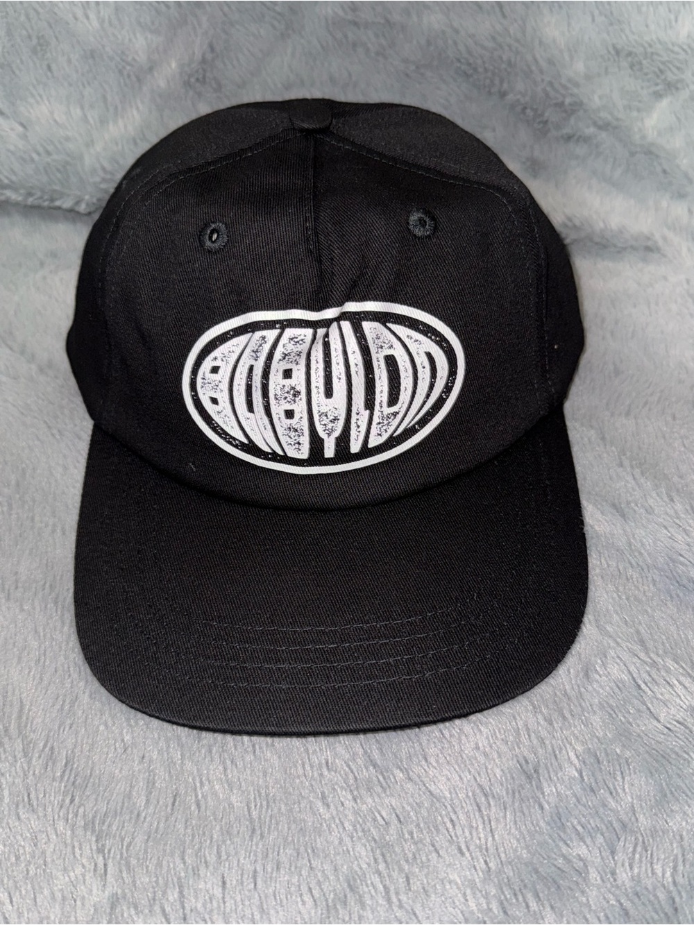 Black Babylon Baseball Cap with White Oval Graphic